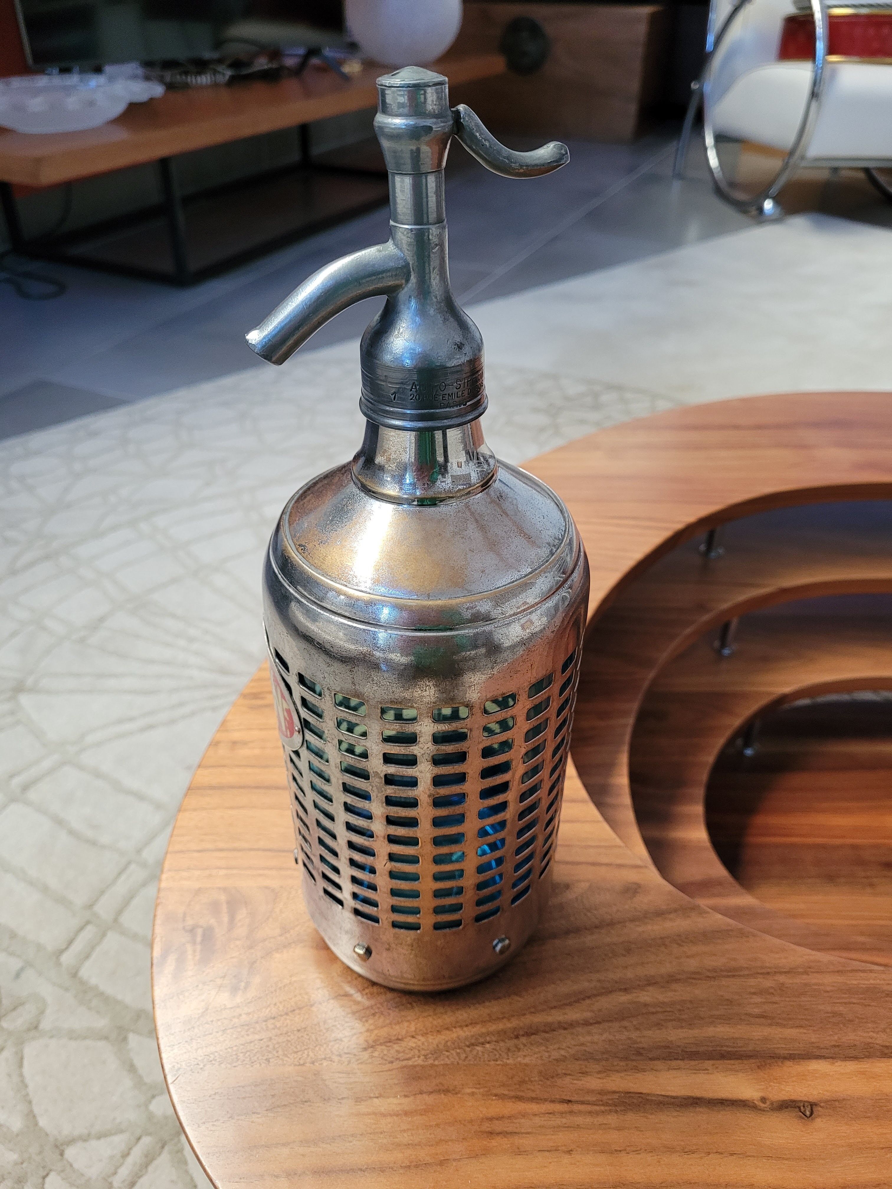 Seltzer water siphon in its protective grid