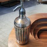 Seltzer water siphon in its protective grid