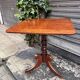 19th-century solid mahogany table with a tilting top and brass mechanism.