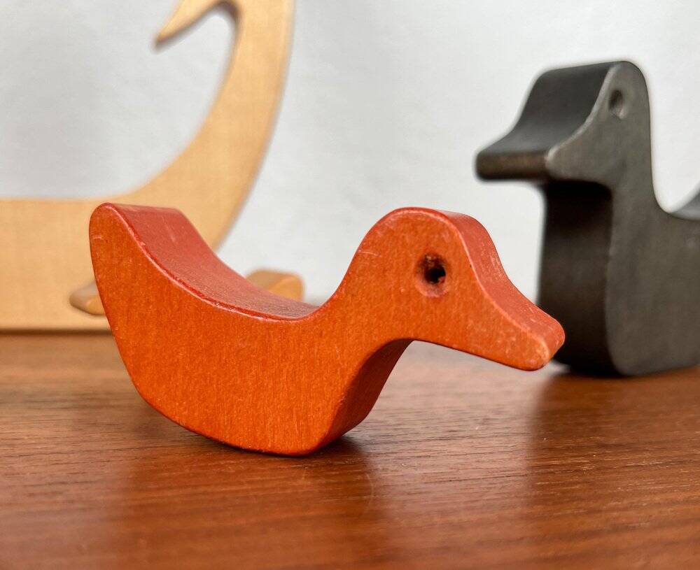 Vintage wooden puzzle with duck figurines.