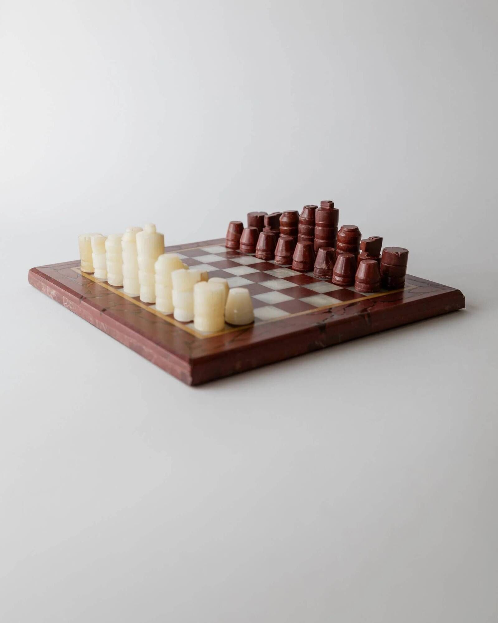Vintage marble chess set from the 1960s, cream, burgundy and gold board with metal inlay, stone pieces.