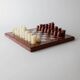 Vintage marble chess set from the 1960s, cream, burgundy and gold board with metal inlay, stone pieces.