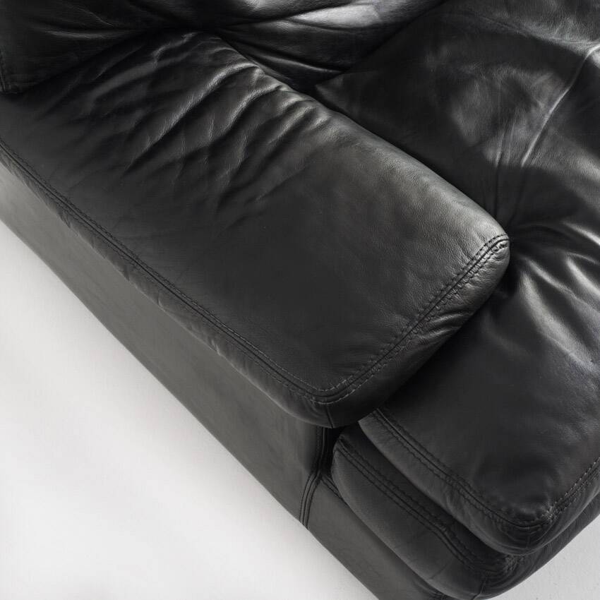 Black leather two-seater sofa. Roche Bobois edition. France, 1980s.