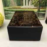Old black wooden box with Asian décor