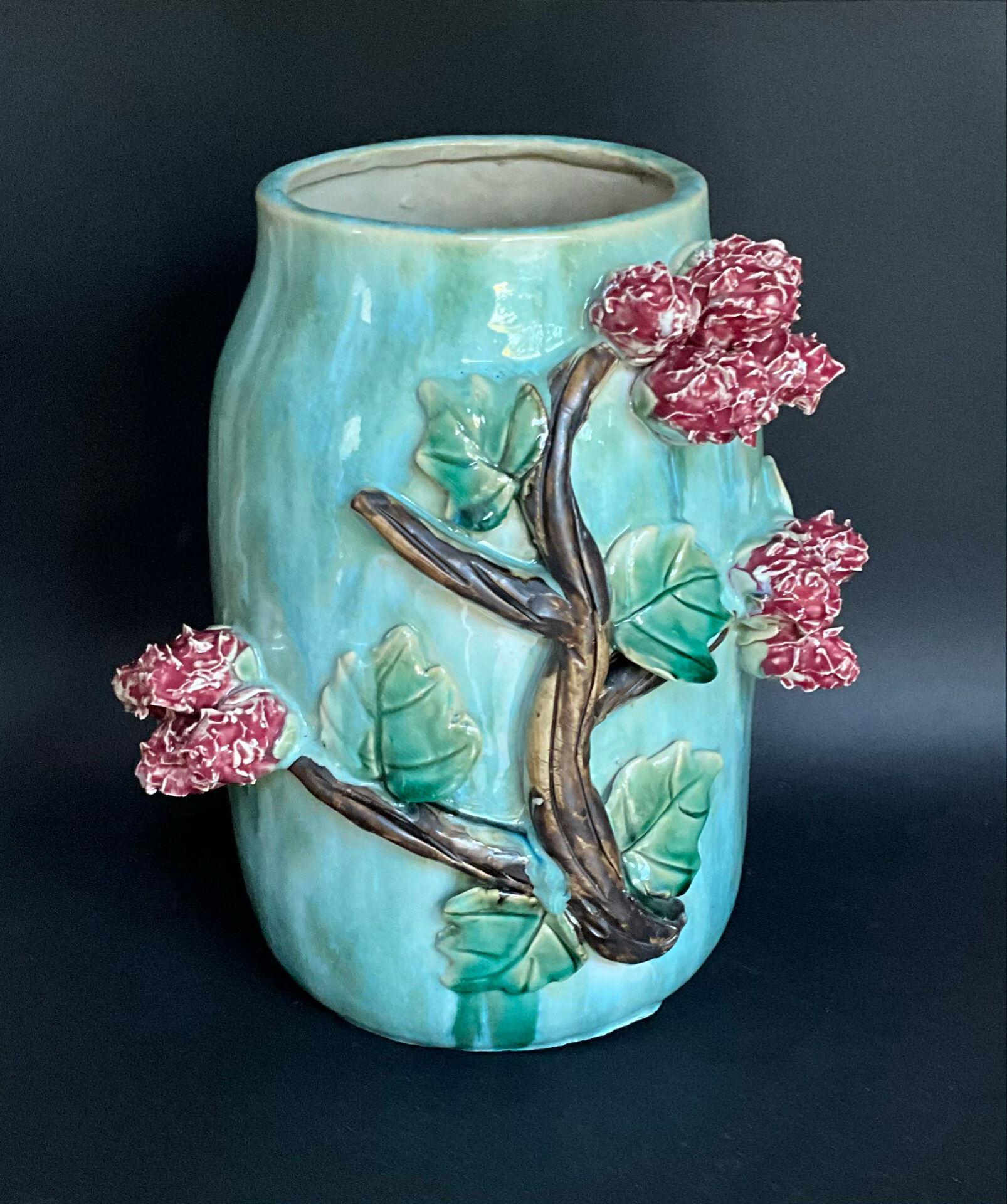 Large turquoise ceramic vase Athezza with raised floral decoration.