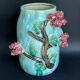 Large turquoise ceramic vase Athezza with raised floral decoration.