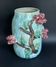 Large turquoise ceramic vase Athezza with raised floral decoration.