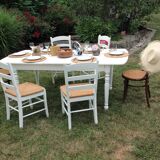 White farmhouse table set and four chairs