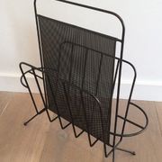 Black lacquered metal and perforated metal magazine rack designed by Mathieu Matégot 50.