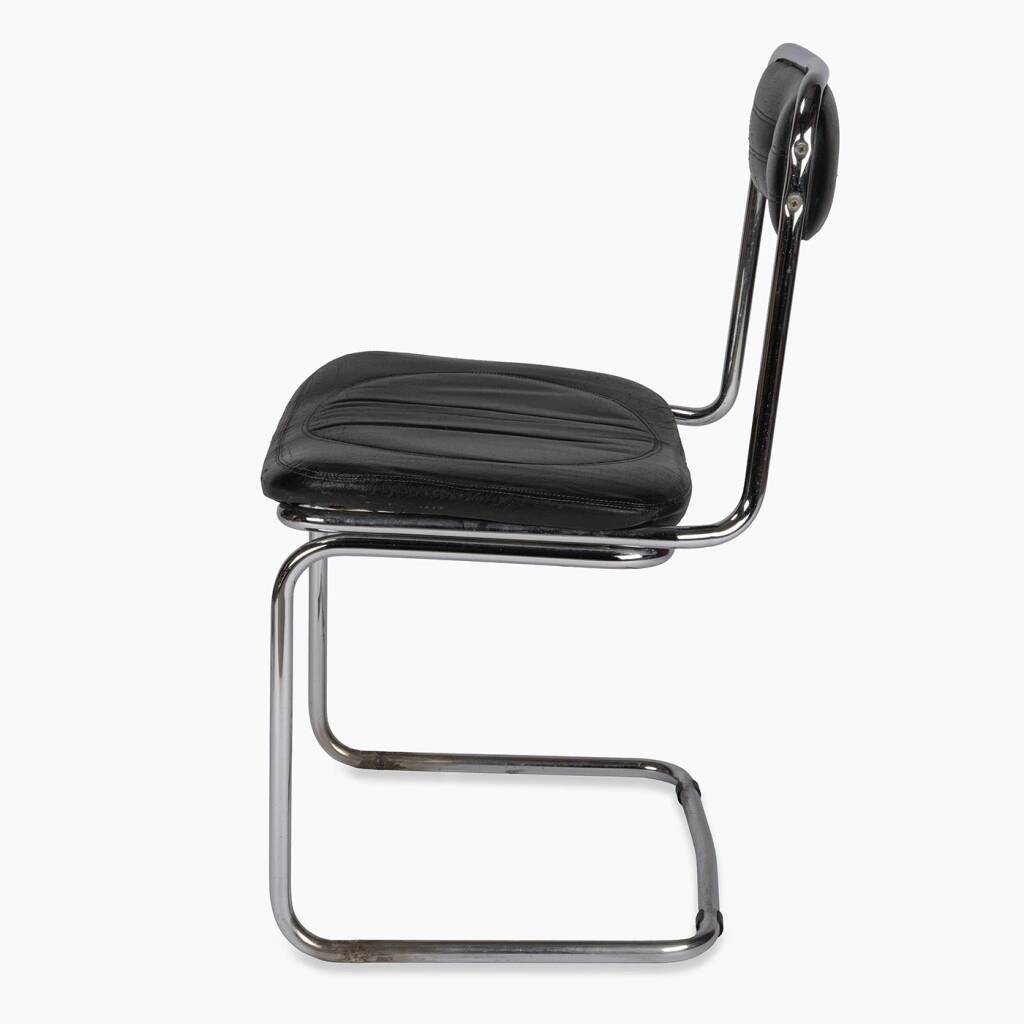 Tube chair with chrome steel base and seat and backrest made of soft black leatherette.