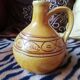 Round ochre glazed jug with handle