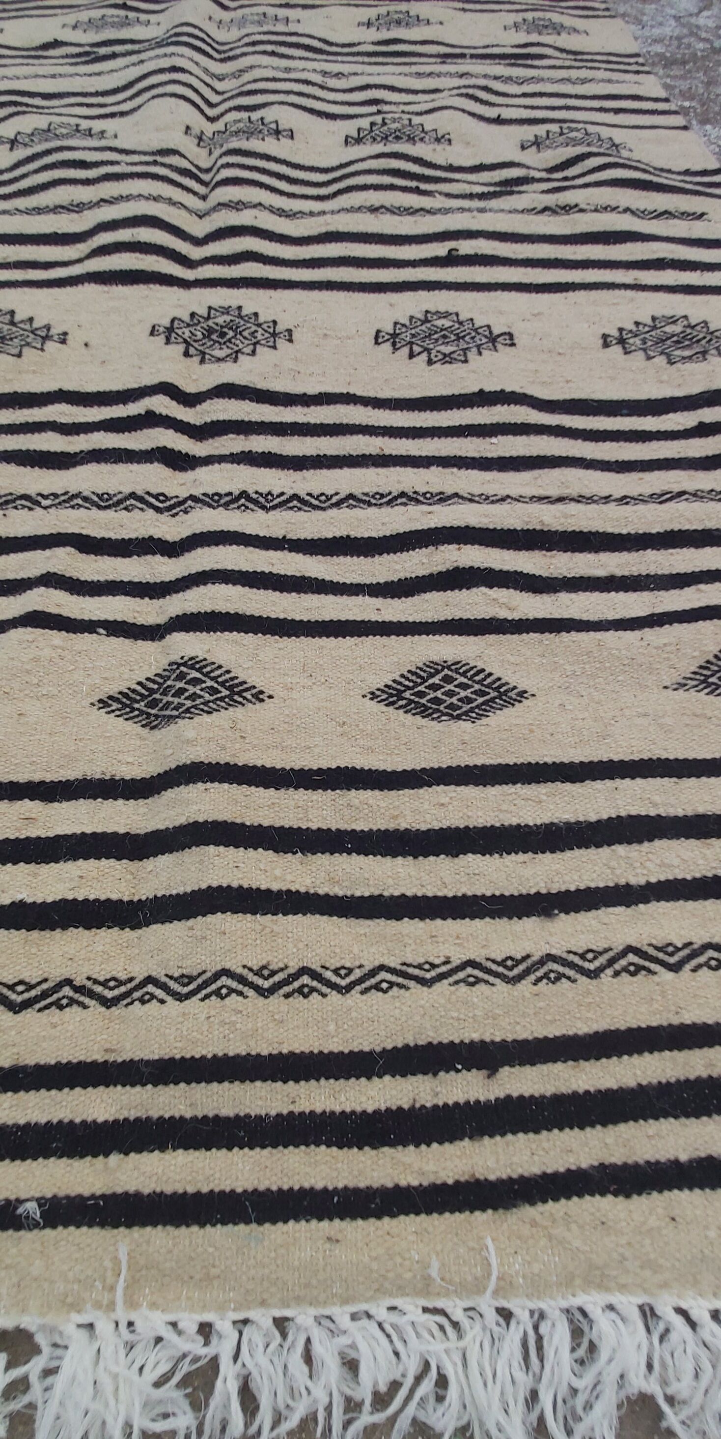 Traditional hand-woven beige and black carpet