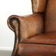 Sheepskin wingback armchair with patina finished with decorative nails