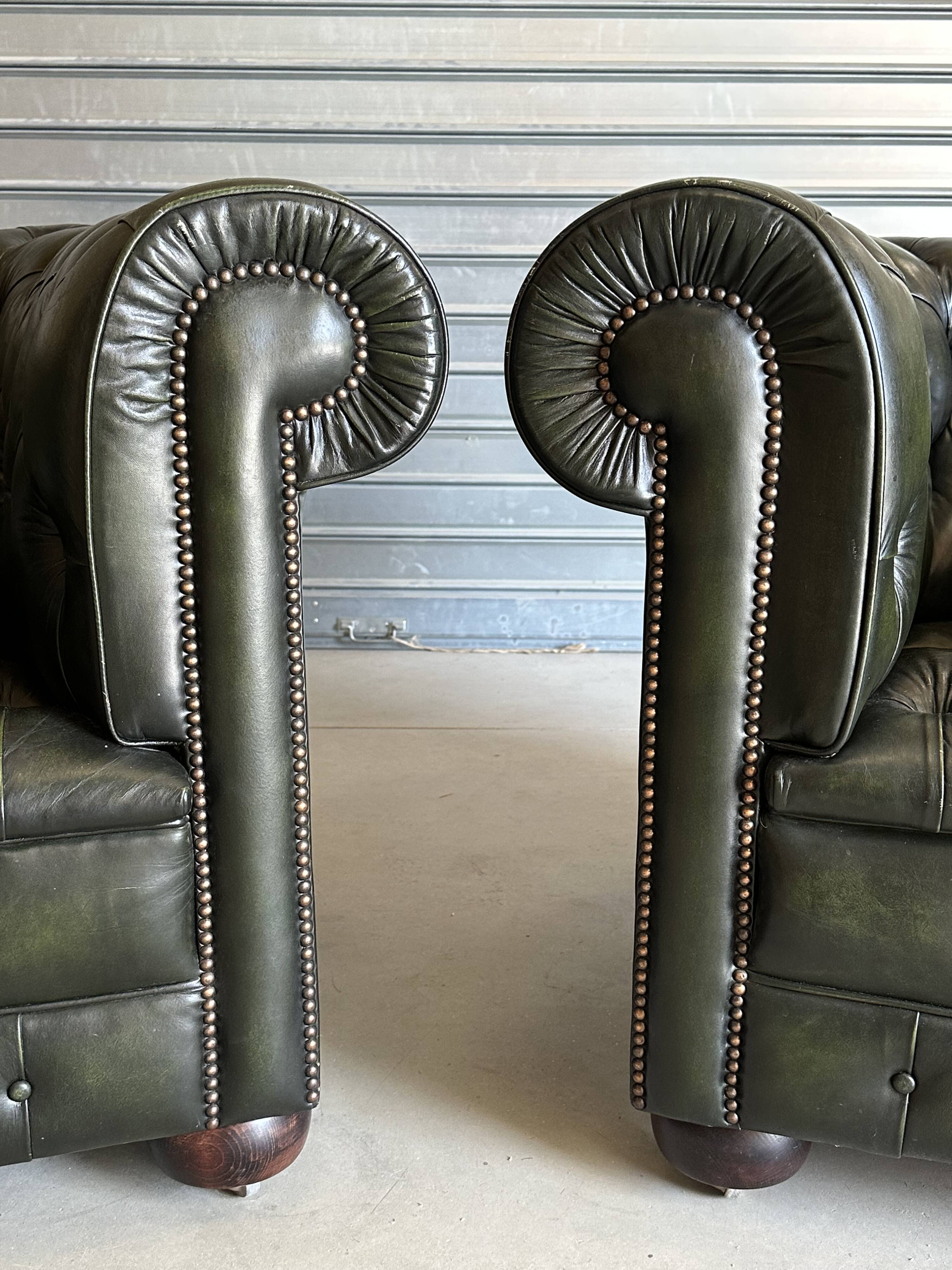 Title: Pair of vintage olive green leather Chesterfield armchairs