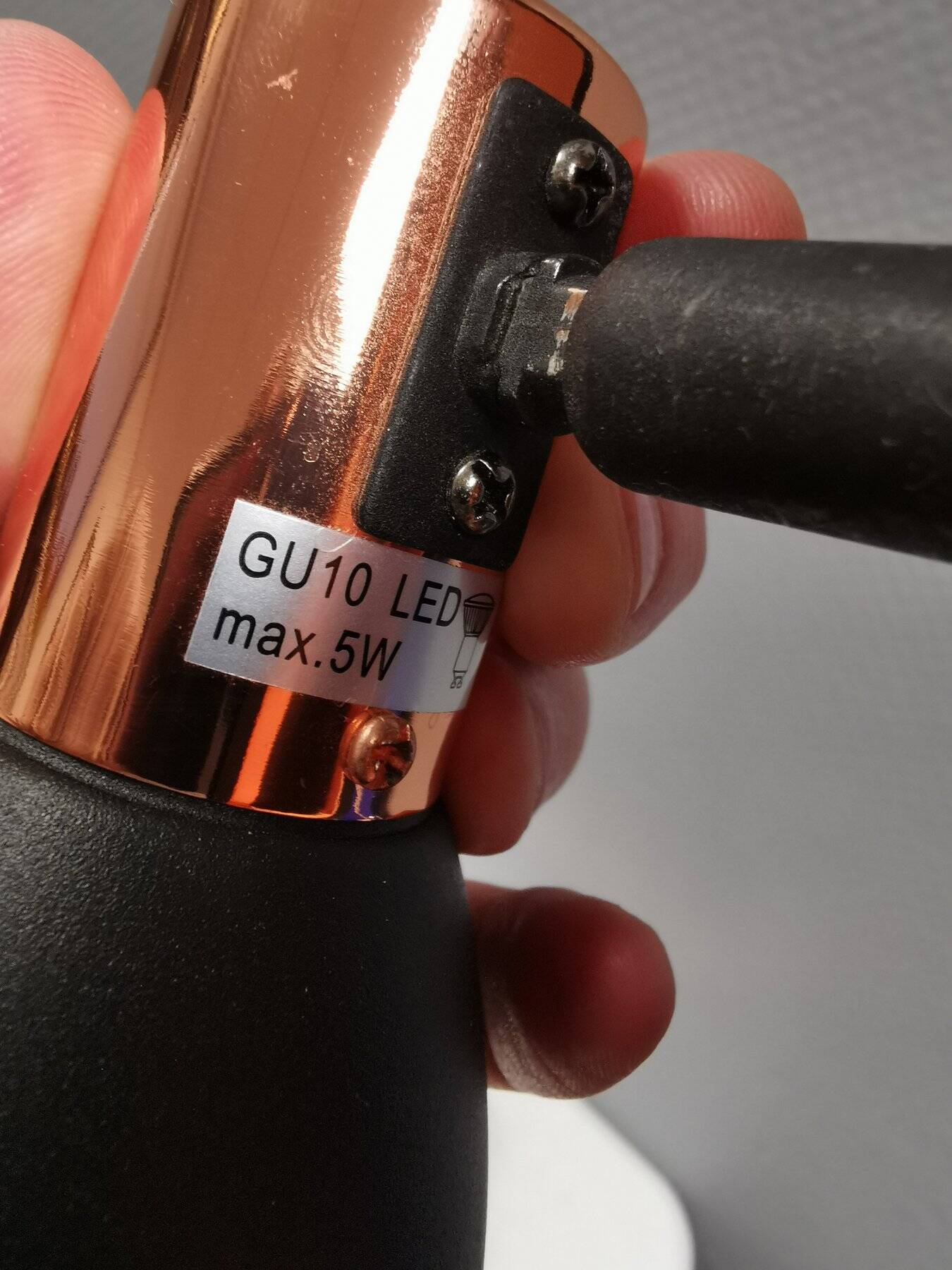 A pair of wall lamps from Eglo, in copper color and black.