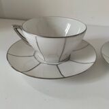 Two Art Deco porcelain cups and saucers with silver trim.