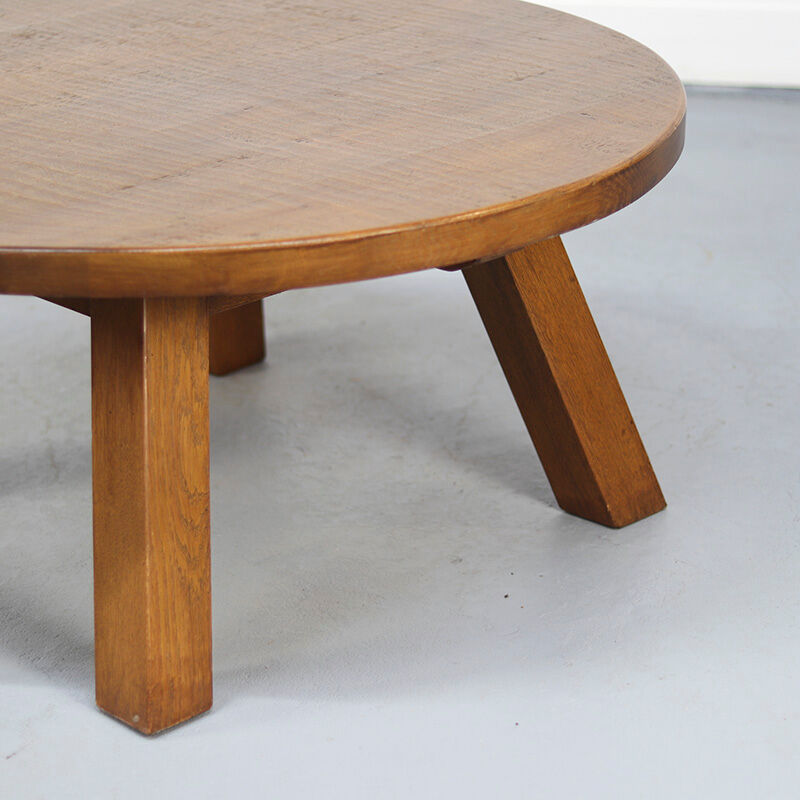 Large rustic vintage coffee table in a round brutalist style.