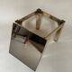 Set of three nesting side tables in brass and smoked mirror.