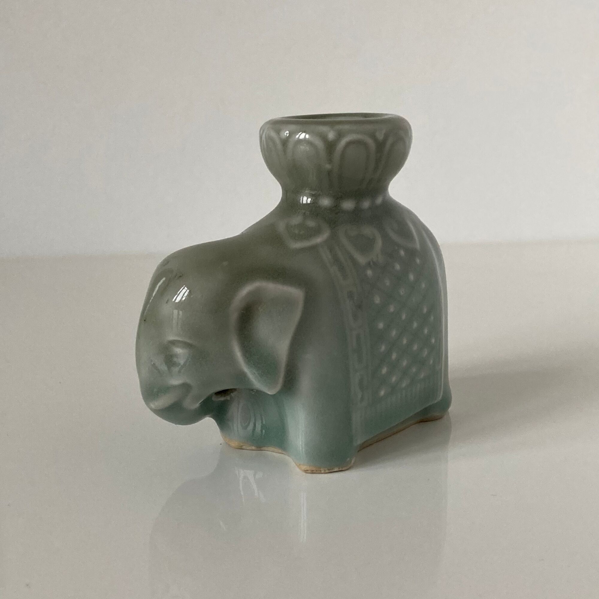 Porcelain candle holder and celadon cover in the shape of an elephant