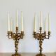 Solid bronze candlesticks decorated with putti, acanthus leaves and lion heads