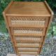 Vintage rattan chest of drawers with splayed legs from the 1950s.