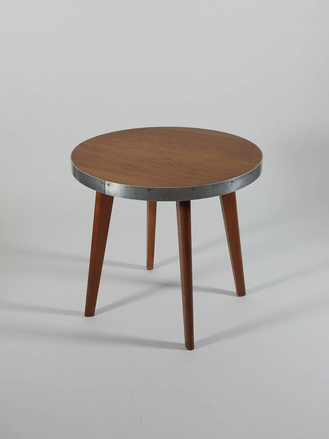 Vintage metal and teak side table from the 1950s.