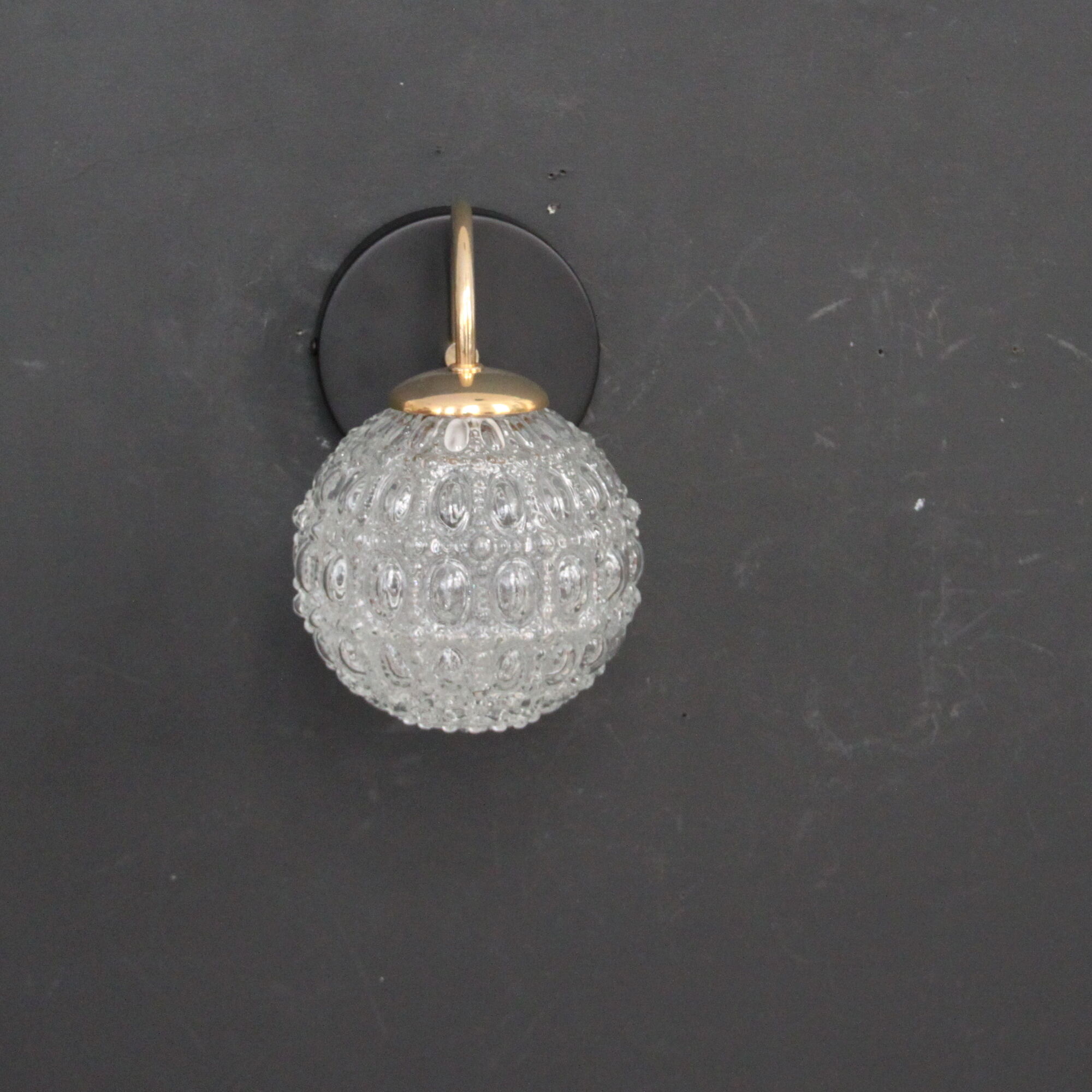 Globe wall light in moulded glass, brass swan collar, circa 1950