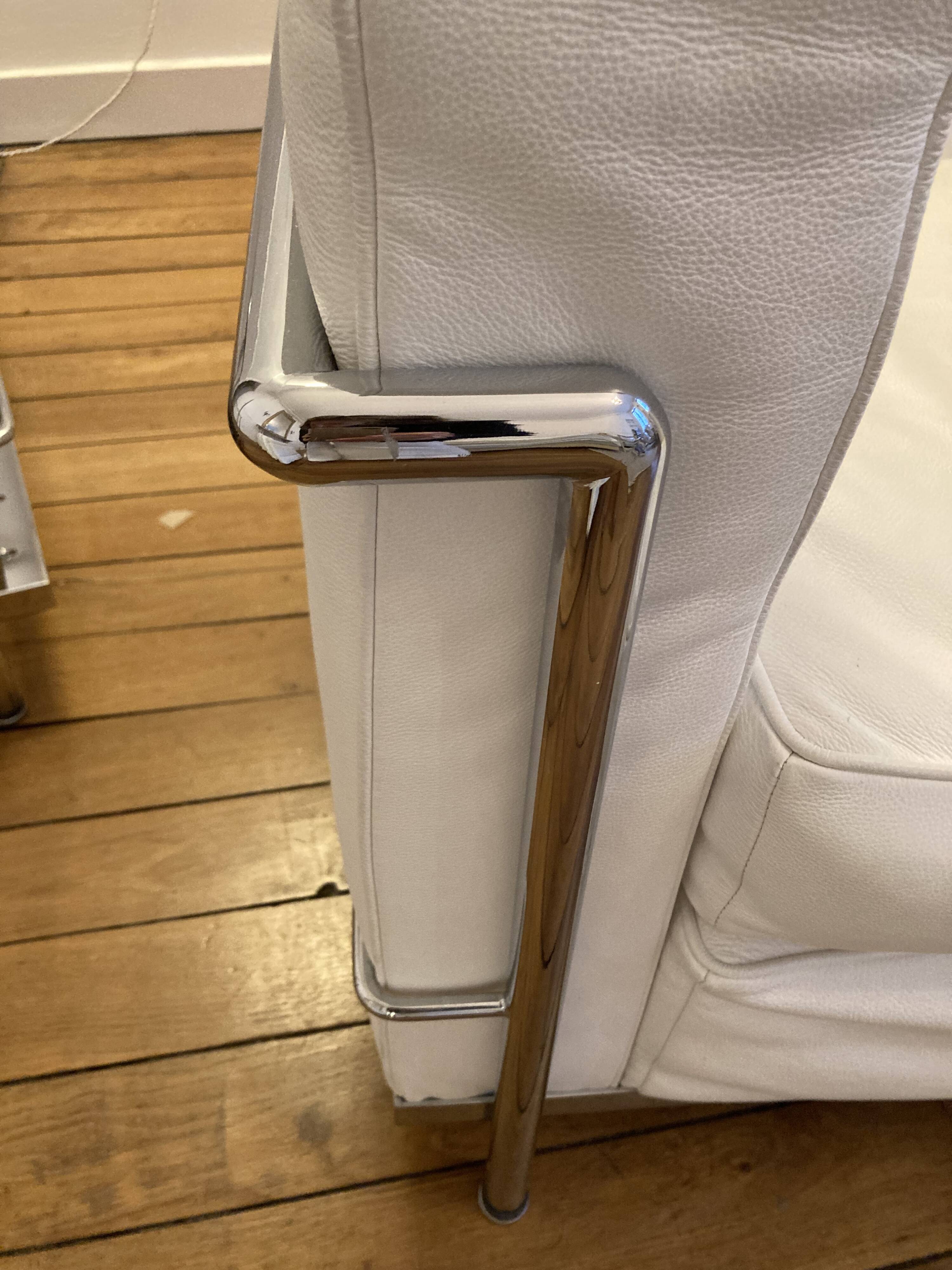 Pair of white leather and chrome armchairs