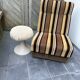 Vintage 1970s lounge chair – striped orange, brown, and cream velvet