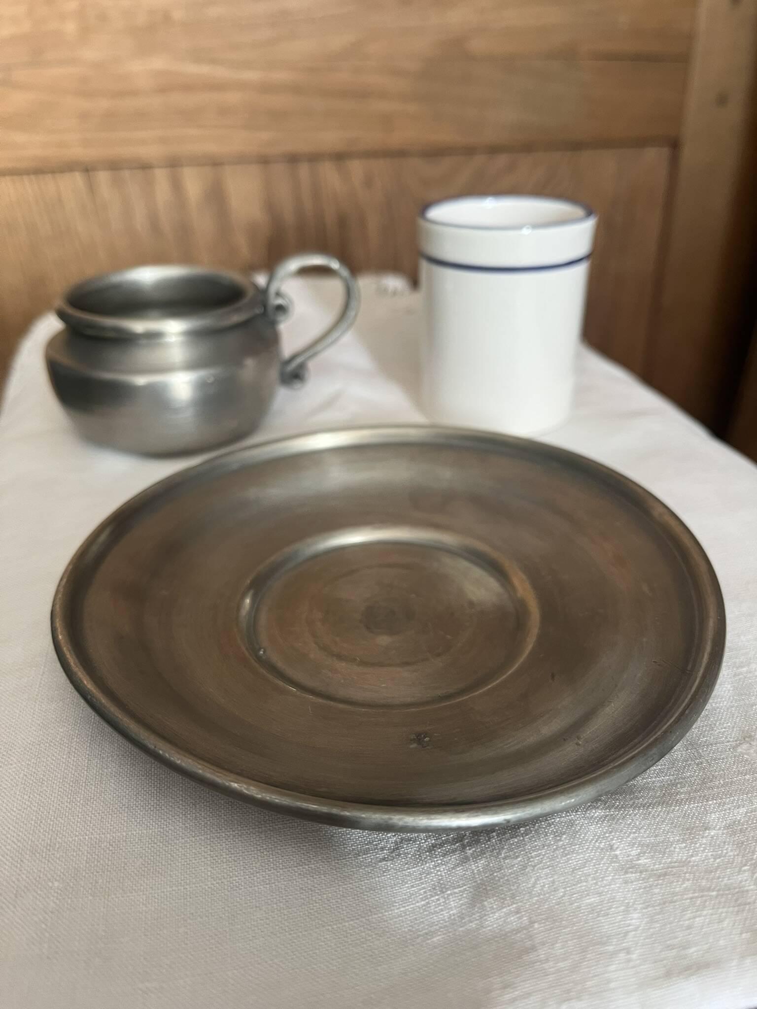 Pewter and porcelain cup and saucer