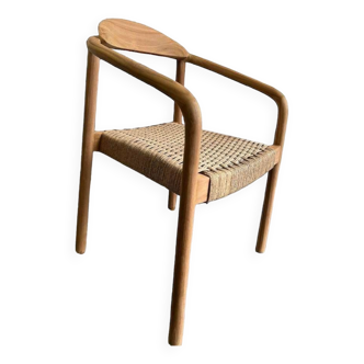 Solid wood chair with weaved seat and armrests