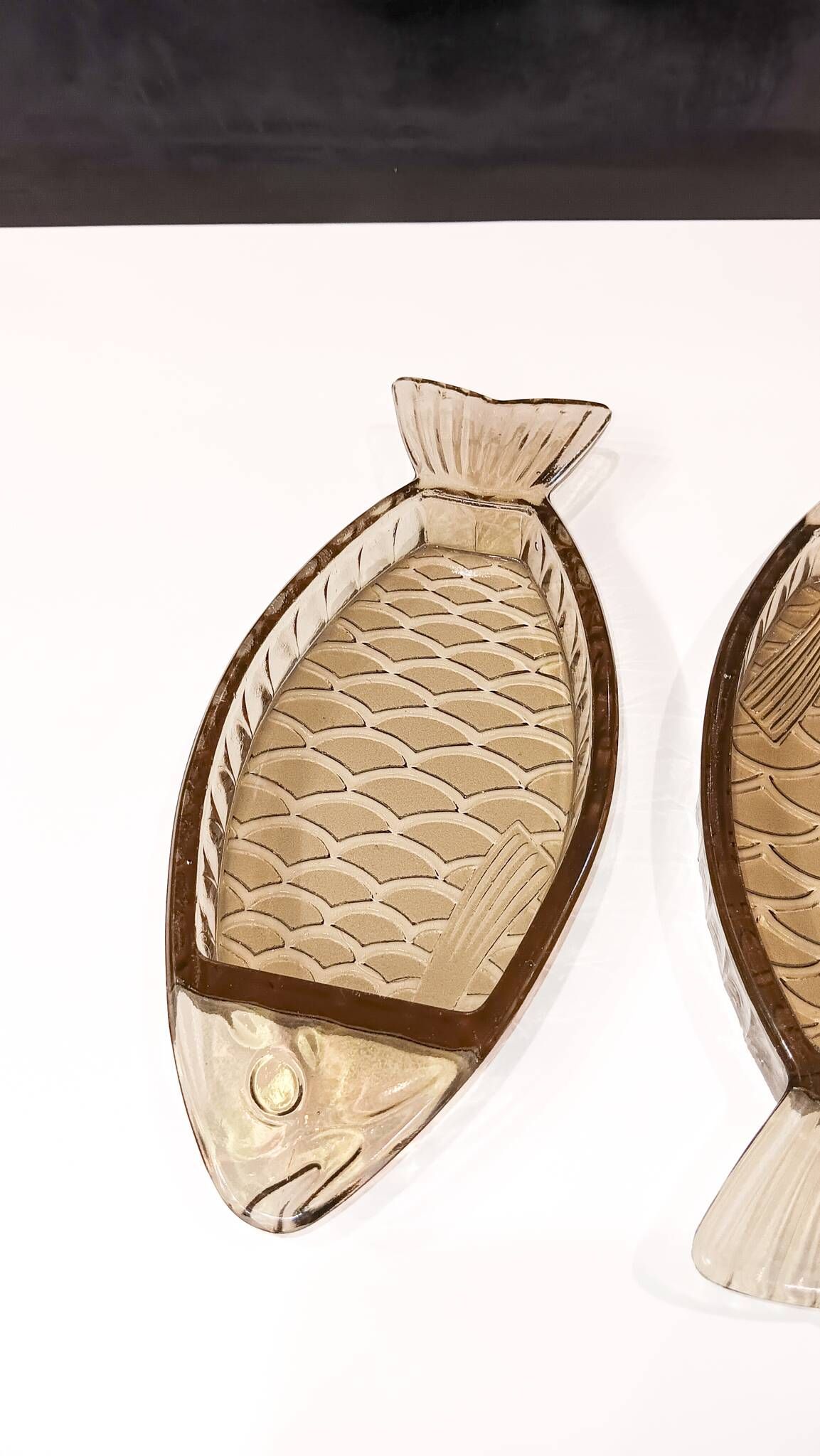 Set of 2 transparent smoked glass bowls in the shape of a fish.