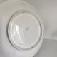 Decorative plate with relief floral pattern in majolica.