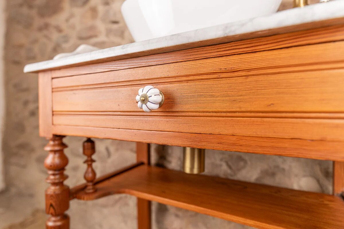 Antique washbasin cabinet in solid pitch pine with a white marble top.