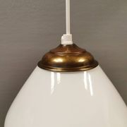 Beautiful ball-shaped hanging lamp in white opal glass with brass top.