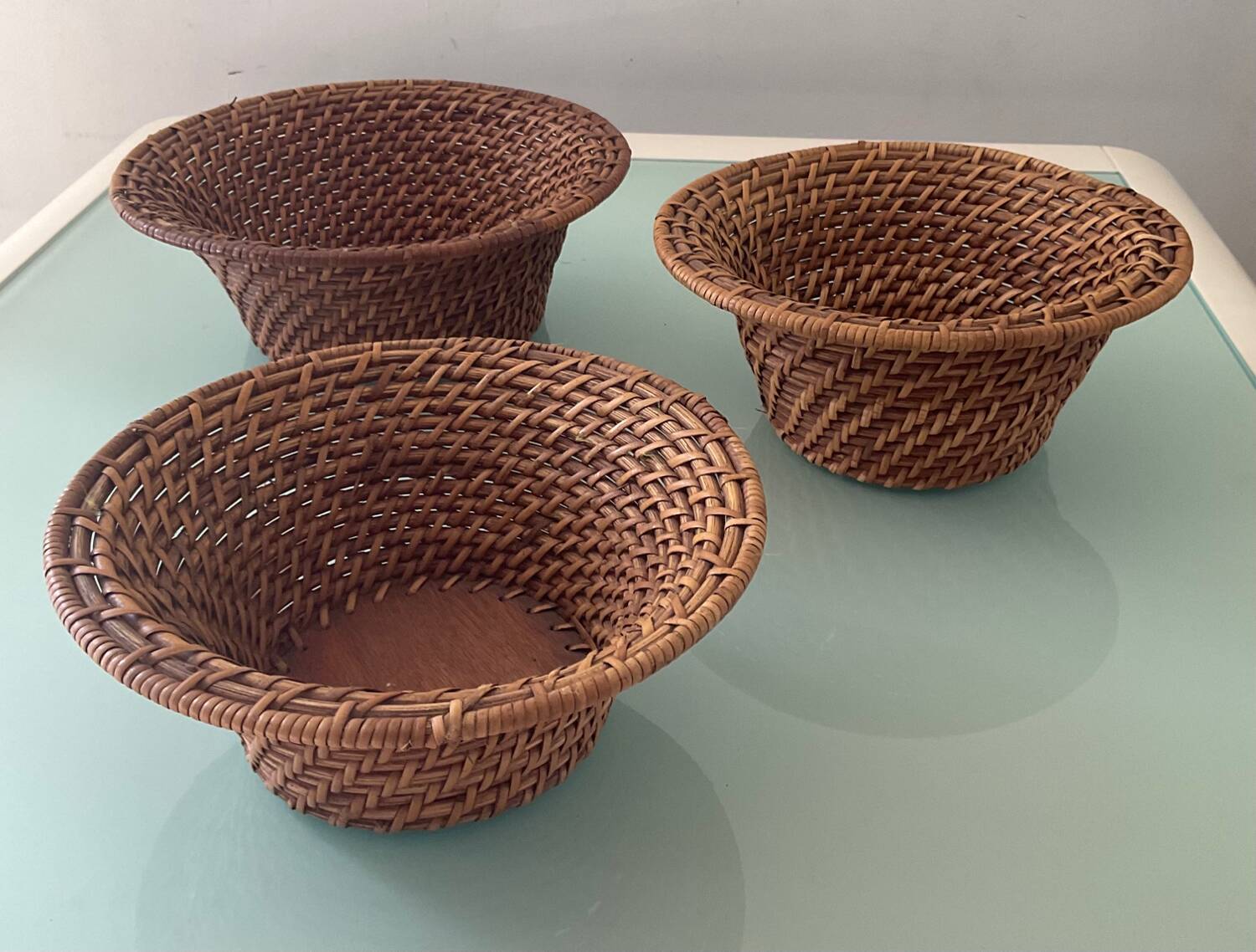 Trio of vintage woven rattan and wicker baskets