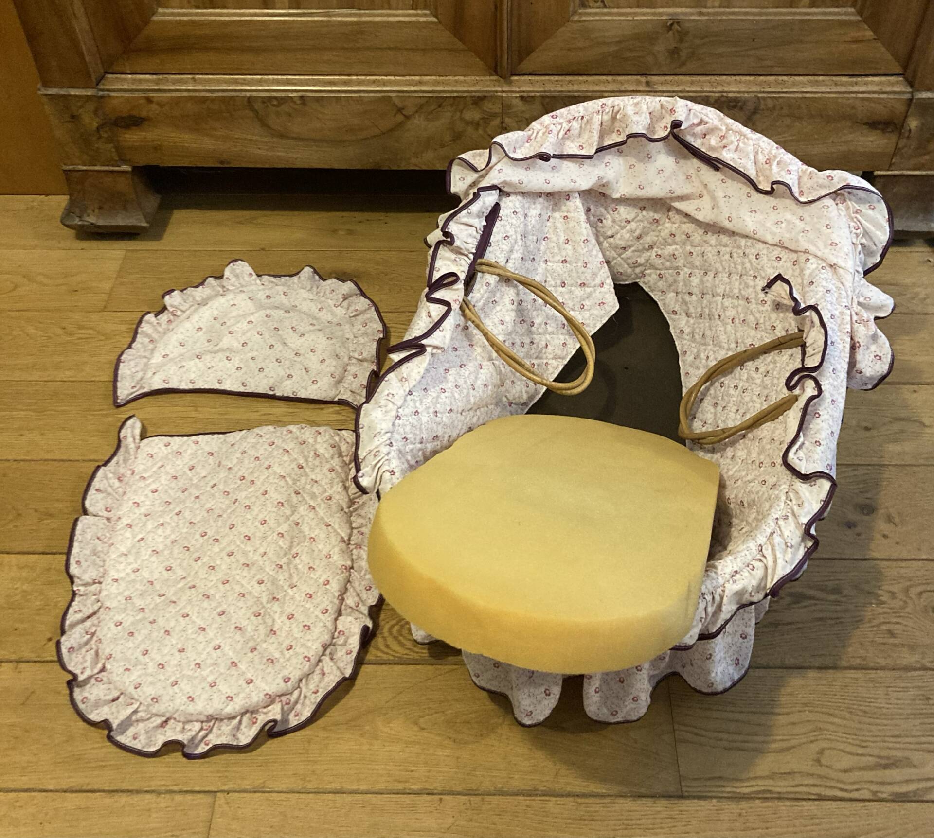 1960s wicker cradle with mattress and drapes.