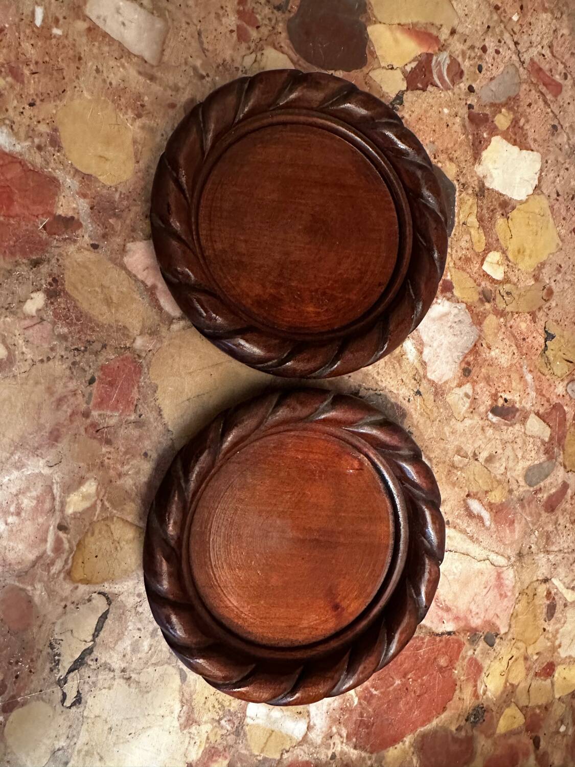 Pair of turned and carved wooden bottle coasters from the 1950s.