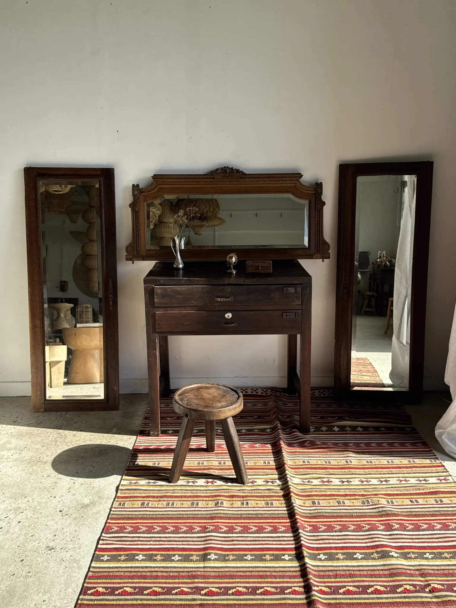 Antique mirror door (left) of a brown oak wardrobe with bevelled glass.