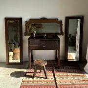 Antique mirror door (left) of a brown oak wardrobe with bevelled glass.