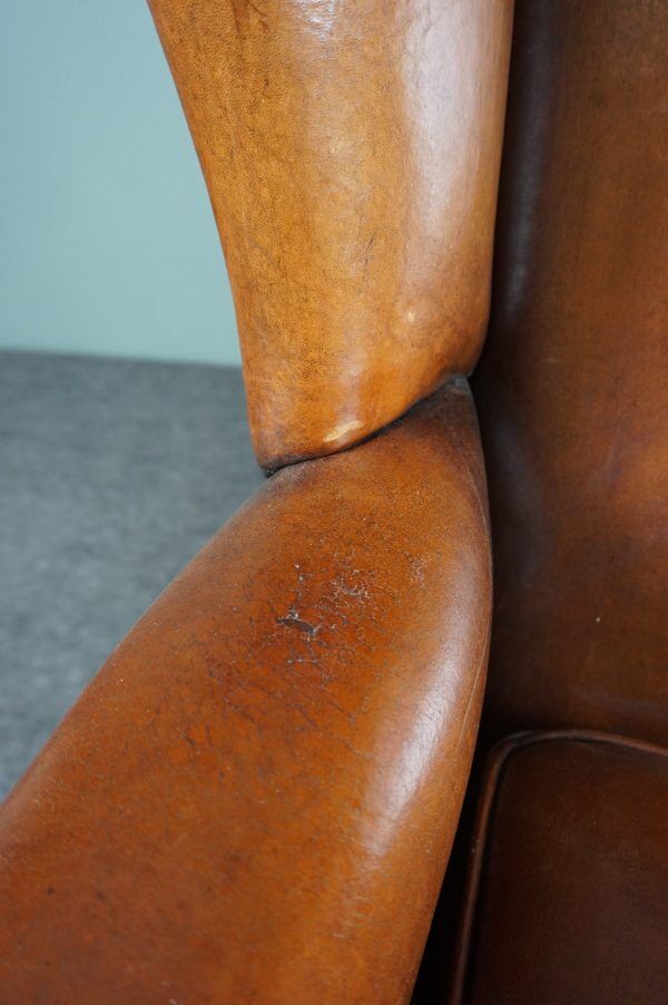 Eared armchair in patinated sheepskin