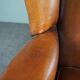 Eared armchair in patinated sheepskin