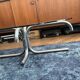 Oval glass coffee table with chrome legs, vintage 70s design.