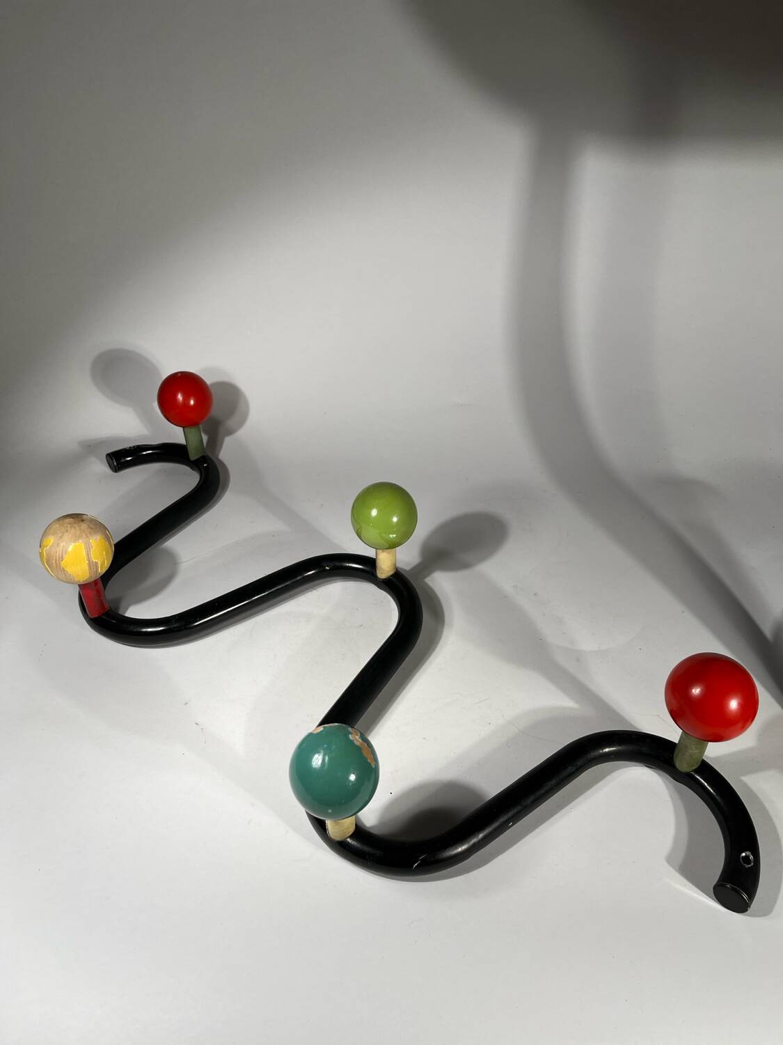 Coat rack in black lacquered metal and colored wooden balls