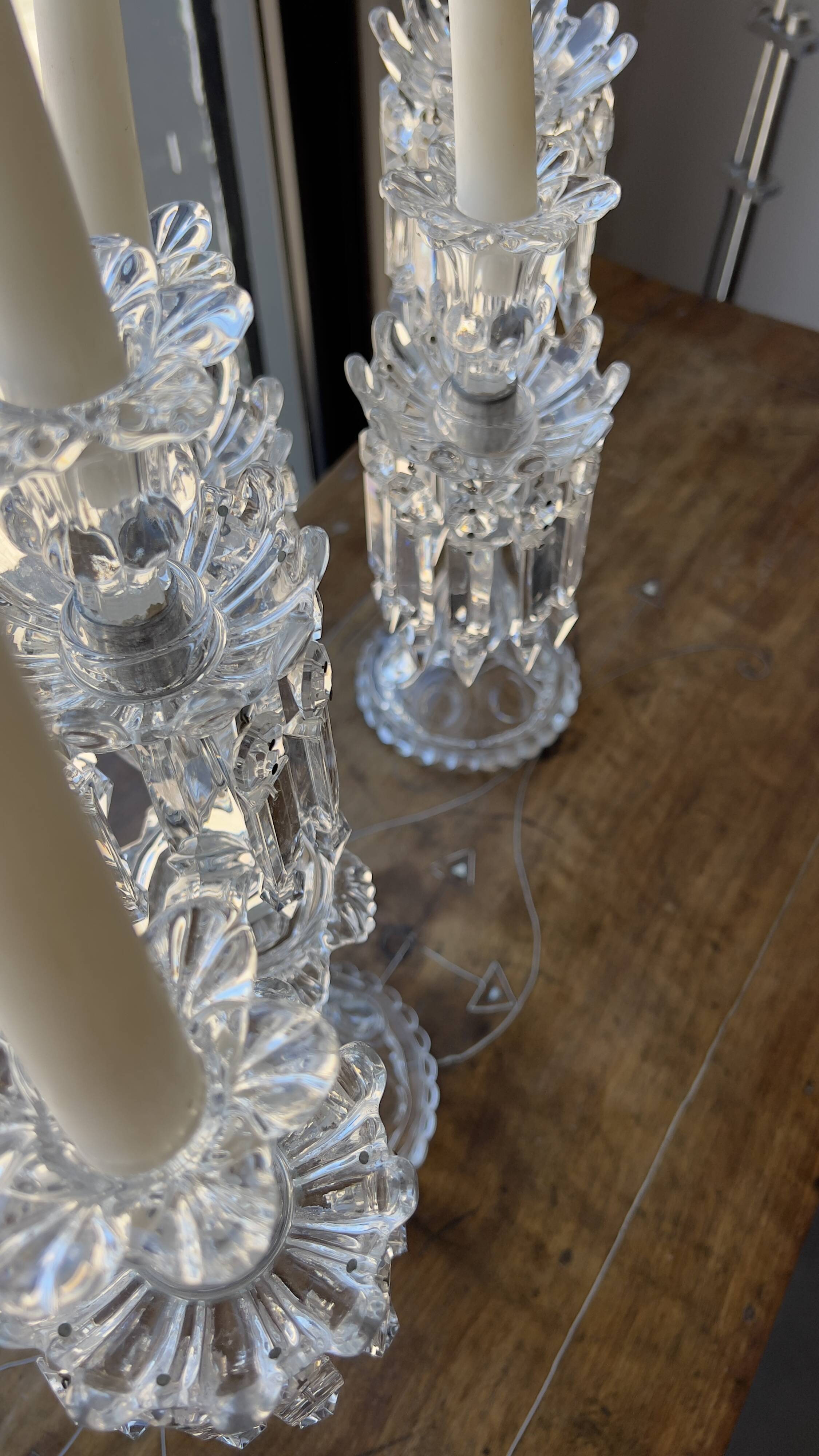 Pair of Baccarat three-light crystal chandeliers