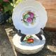 Antique plates from the late 19th century with scalloped edges and fruit decoration.
