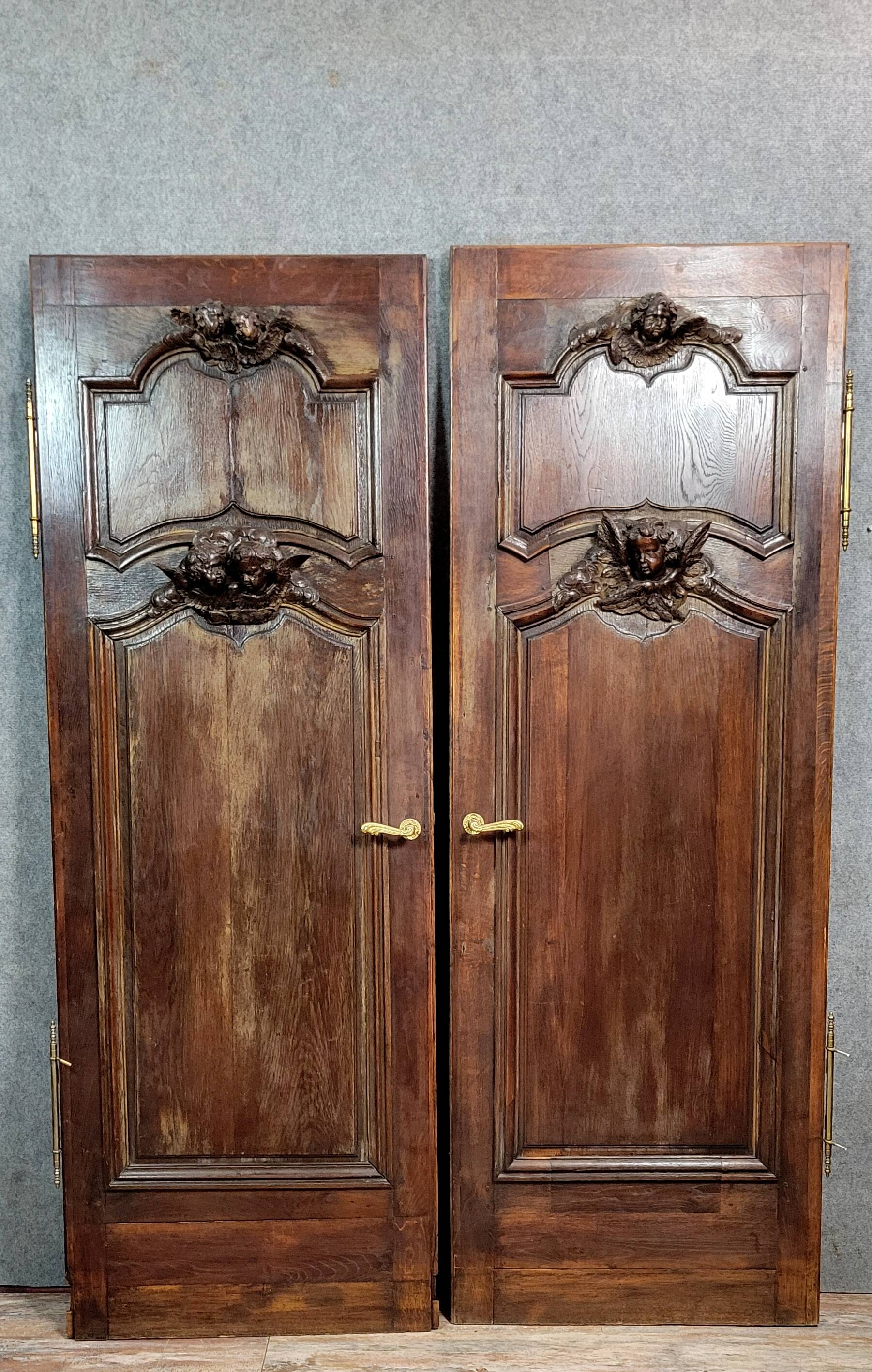 Pair of 18th century oak woodwork castle doors with putti