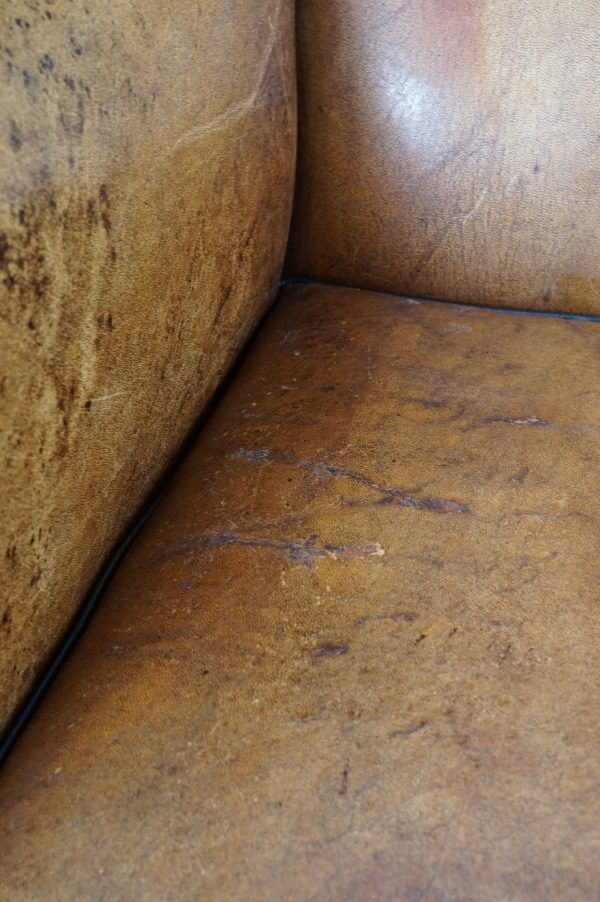 Antique armchair in patinated sheepskin