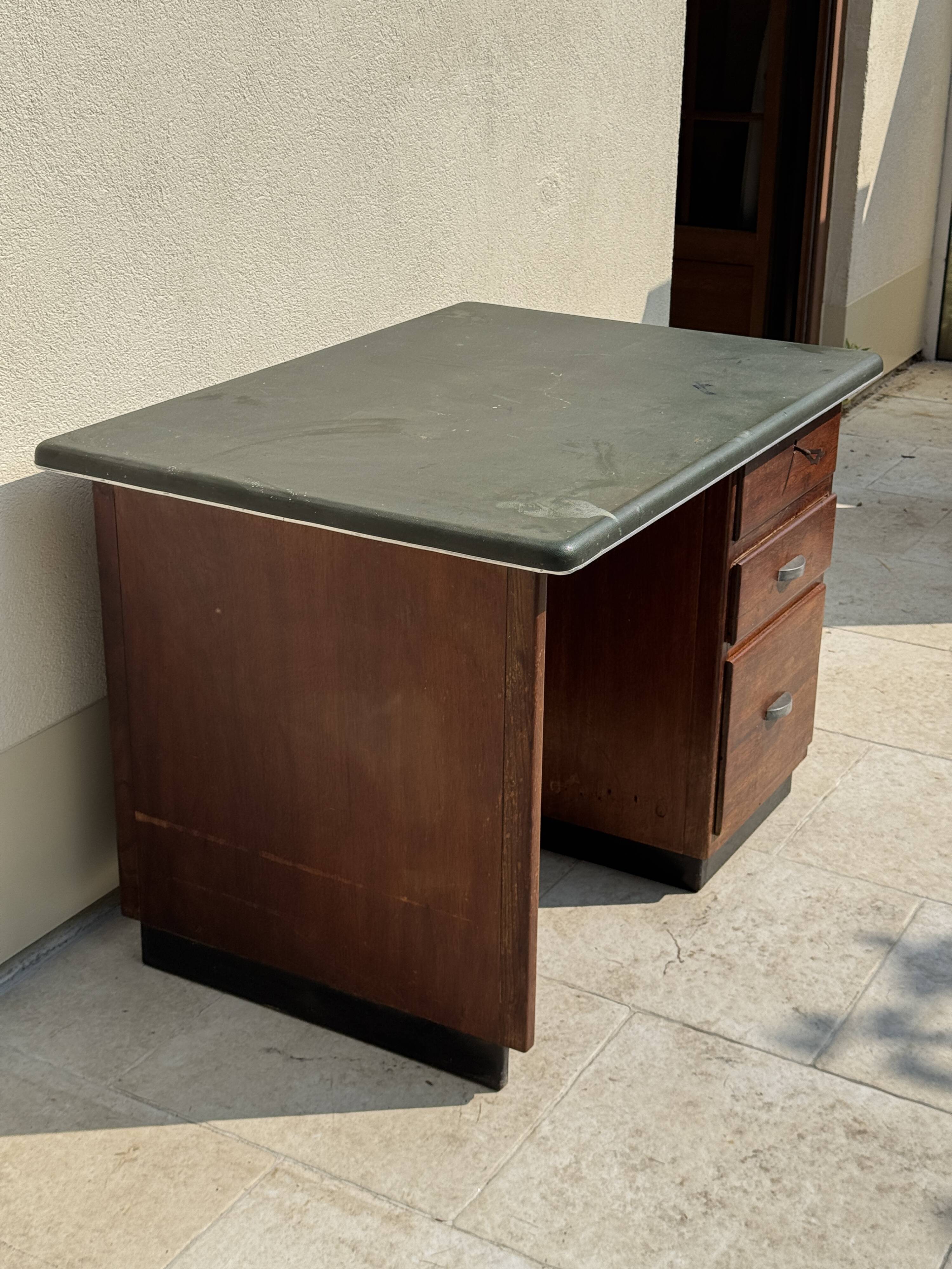 Modernist desk in wood and green moleskin upholstery