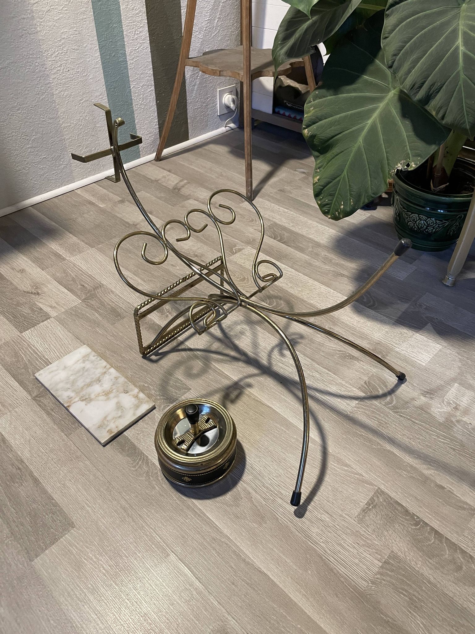 Gold wrought iron ashtray on legs with magazine rack and marbled shelf